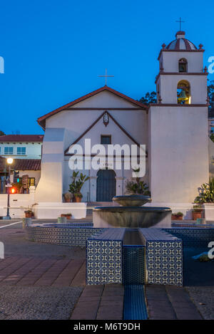 San Buenaventura Mission on Main Street in City of Ventura under blue sky behind water fountain and canal looking up Figeuroa Street toward bell tower. Stock Photo