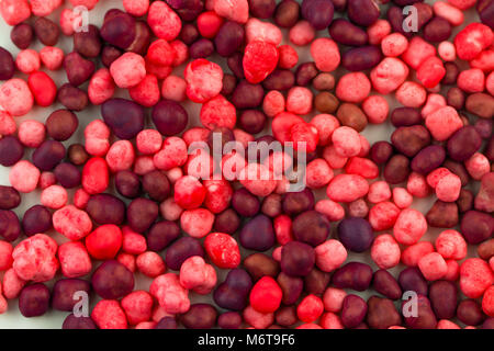 sweet pink and purple candies spreading pastry decoration background. Stock Photo