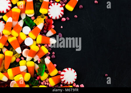 Colorful candies and  jelly on a black background background. Top view with copy space. Stock Photo
