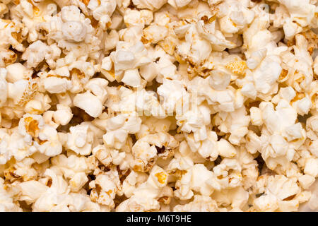 Scattered salted popcorn, texture background. Close up.The view from the top. Stock Photo