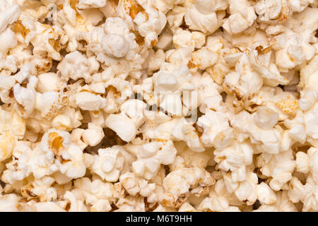 Scattered salted popcorn, texture background. Close up.The view from the top. Stock Photo