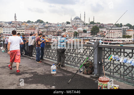 Istanbul, Turkey - June 26, 2016: Fishermen are fishing on Galata bridge in Istanbul, Turkey Stock Photo