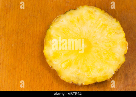 Ripe sliced pineapple on wooden table, top view. Stock Photo