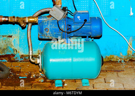 An old and rusty abandoned electric pump on an abandoned and destroyed factory against a backdrop of chaos. Destruction and vandalism. Ukraine. Stock Photo