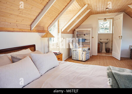 Spacious attic bedroom with bathroom in a home Stock Photo