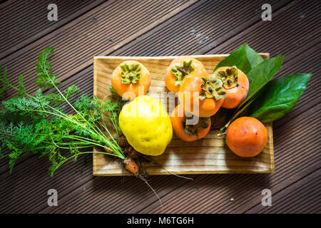 Home Harvest - Persimmon, Quince and Carrot Stock Photo