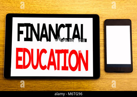 Writing text showing Financial Education. Business concept for Finance Knowledge Written on tablet, wooden background with sticky note and pen Stock Photo