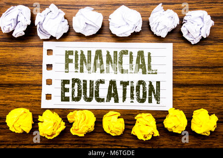 Handwritten text showing Financial Education. Business concept for Finance Knowledge Written on sticky, wooden with sticky, many folded paper white an Stock Photo