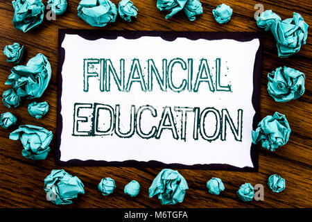 Handwriting Announcement text showing Financial Education. Business concept for Finance Knowledge Written on sticky note paper, wooden background fold Stock Photo