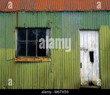 A weathered painted metal shed in County Mayo, Ireland. Stock Photo