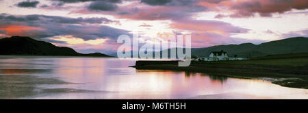 Panoramic view of calm reflections and a sunset over Loch Linnhe in the Scottish Highlands. Stock Photo