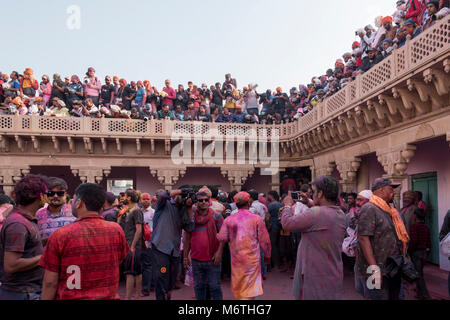 People celebrating holi in Nandgaon, India. Holi is an annual Hindu festival celebrated in North India. Stock Photo