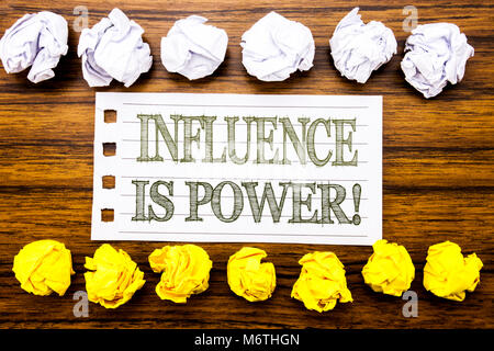 Handwritten text showing Influence Is Power. Business concept for Persuasion Strategy Written on sticky, wooden with sticky, many folded paper white a Stock Photo