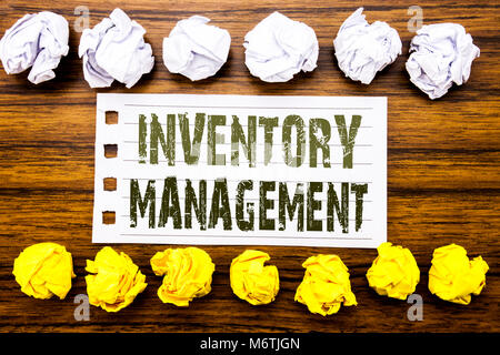 Handwritten text showing Inventory Management. Business concept for Stock Supply Written on sticky, wooden with sticky, many folded paper white and ye Stock Photo