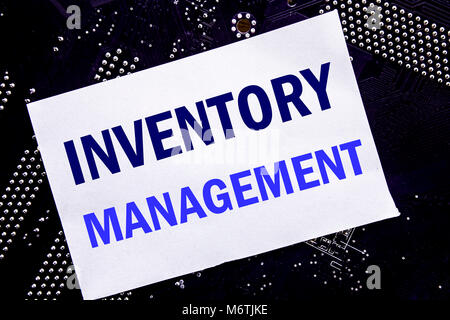 Handwritten text showing Inventory Management. Business concept for Stock Supply Written on sticky, computer main board background. Stock Photo