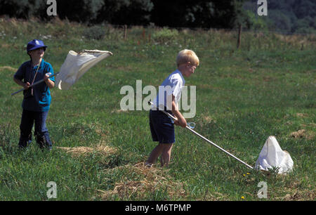 Two little sisters catching butterflies and bugs with their scoop-nets.  Children exploring nature on sunny summer day. Family leisure with kids at  sum Stock Photo - Alamy