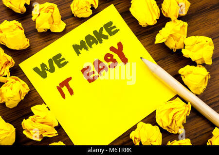 Word, writing We Make It Easy. Business concept for Help Quality Solution Written on sticky note paper, wooden background folded yellow paper meaning  Stock Photo