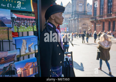 A  rack with postcards and a mannequin dressed in traditional Scottish kilt outside a souvenirs shop in Glasgow, Buchanan street. Stock Photo