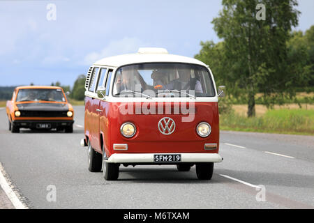 SOMERO, FINLAND - AUGUST 5, 2017: Classic Volkswagen red and white Type 2 camper van moves along highway on Maisemaruise 2017 car cruise late summer e Stock Photo