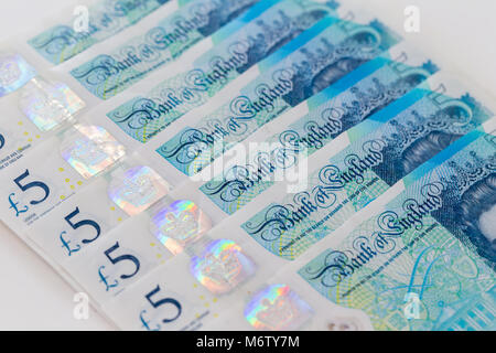 Background of five UK pound sterling banknotes, arranged in a row Stock Photo