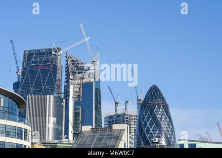 Construction cranes on London skyline in the City of London. The Scalpel Gherkin Cheesegrater Leadenhall Building Stock Photo