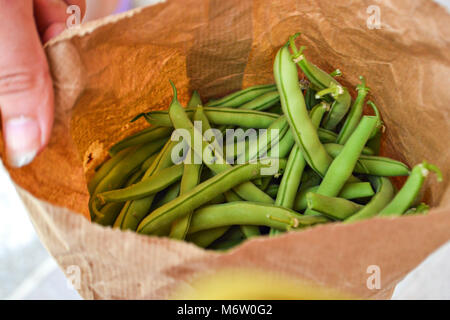 Green peas in the paper bag, closeup food photography Stock Photo