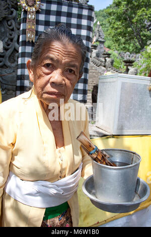 portrait of a woman at a temple with water for a cleaning ritual Stock Photo