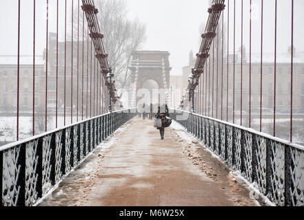 South Portland Street suspension bridge over the river Clyde covered in snow following the 'beast from the east' storm, Glasgow, Scotland. Stock Photo
