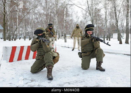 Ukrainian soldiers (strike forces)took position guarding roadblock. National guard of Ukraine exercises. February 1, 2018. Novo-Petrivtsi,Ukraine Stock Photo