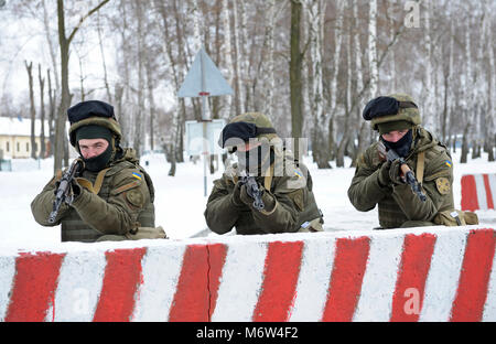 Ukrainian soldiers (strike forces) took position guarding roadblock. National guard of Ukraine exercises. February 1, 2018. Novo-Petrivtsi, Ukraine Stock Photo