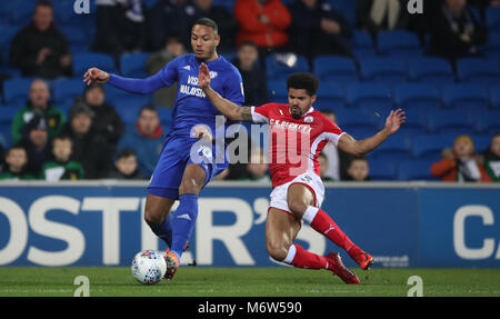Cardiff City's Kenneth Zohore (left) battles for the ball with Barnsley's Zeki Fryers during the Sky Bet Championship match at Cardiff City Stadium. Stock Photo