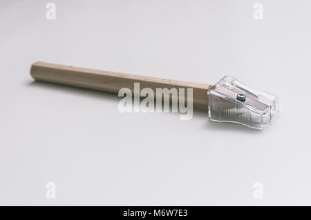 Pencil and a sharpener. Pencil in a transparent sharpener Stock Photo