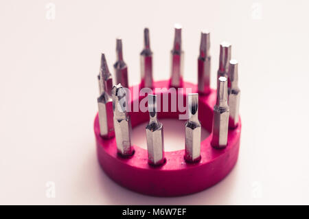 Set of various drivers - isolated - screwdriver bits. Screwdriver bits isolated on a red ring Stock Photo