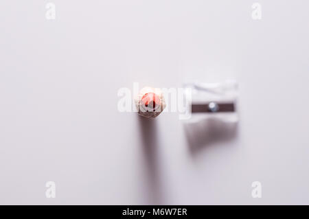 Red pencil and sharpener. Pencil and sharpener isolated on a white background. Stock Photo