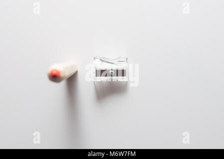Red pencil and sharpener. Pencil and sharpener isolated on a white background. Stock Photo