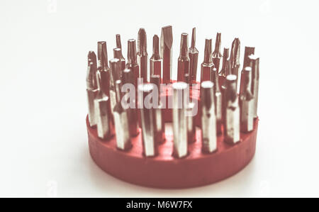 Set of various drivers - isolated - screwdriver bits. Screwdriver bits isolated on a red ring Stock Photo