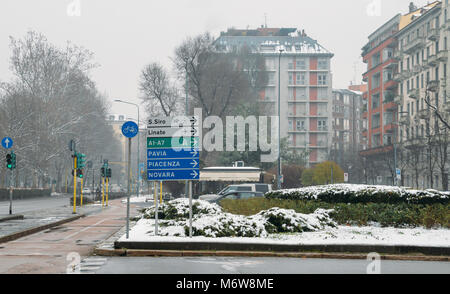 Road signs in Milan, Lombardy, Italy pointing to various landmarks including San Siro stadium and Linate Airport. Stock Photo