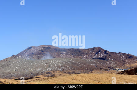 Mt. Aso volcano with the Nakadake crater spewing sulfur steam. Stock Photo