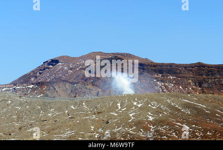 Mt. Aso volcano with the Nakadake crater spewing sulfur steam. Stock Photo