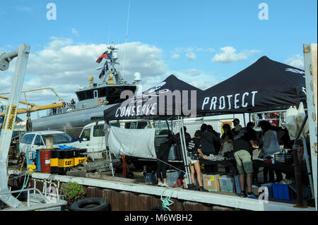 Alongside the moored Sea Shepherd's high speed patrol ship, the 'Ocean Warrior', Sea Shepherd members and supporters sell merchandise to raise funds. Stock Photo