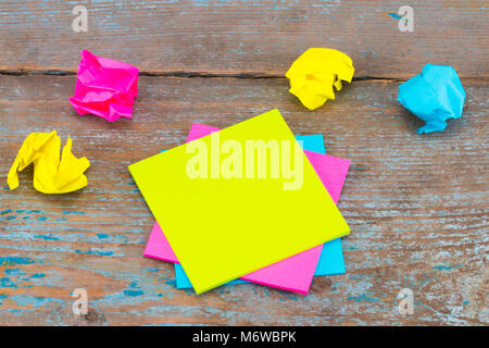 sticky note with crumpled papers  on wooden background, business concept on the sticky note. Stock Photo