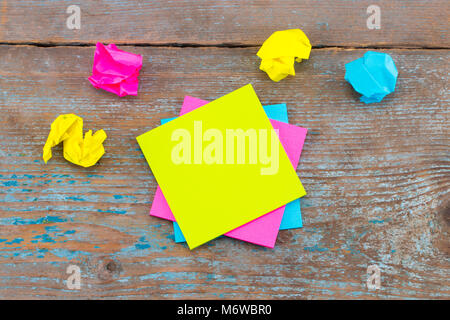 sticky note with crumpled papers  on wooden background, business concept on the sticky note. Stock Photo