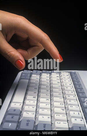 1994 HISTORICAL WOMANS HAND OVER MECHANICAL KEYBOARD OF TOSHIBA T1910CS SATELLITE LAPTOP NOTEBOOK COMPUTER (©TOSHIBA CORP 1994) Stock Photo