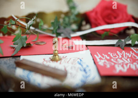 Wedding details calligraphy with flower on wood background Stock Photo