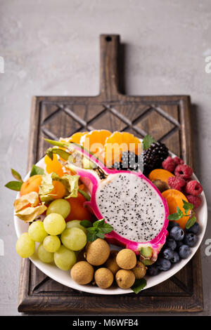 Exotic fruits platter with grapes, dragon fruit, longan and passion fruit Stock Photo