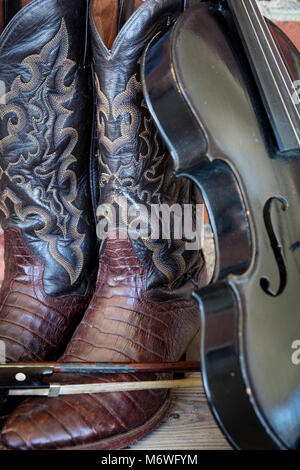 Well-worn cowboy boots and fiddle, Nashville, Tennessee, USA Stock Photo