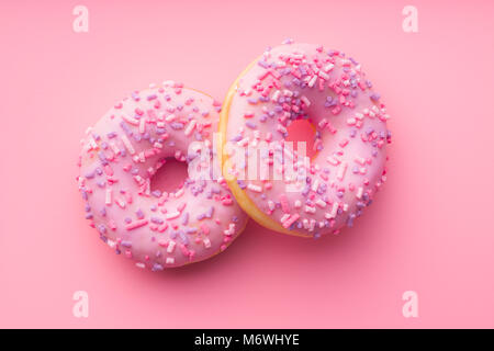 Two pink donuts on pink background. Stock Photo