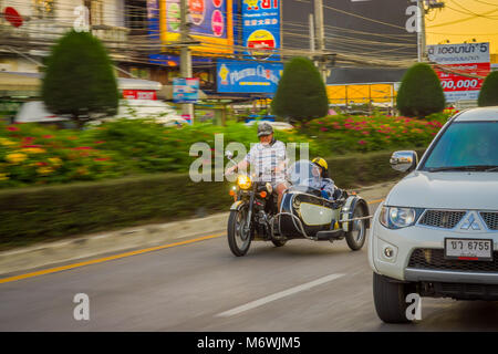 CHIANG RAI, THAILAND - FEBRUARY 01, 2018: Unidentified man using a helmet protection and riding a motorbike is the most popular transport in South Asi Stock Photo