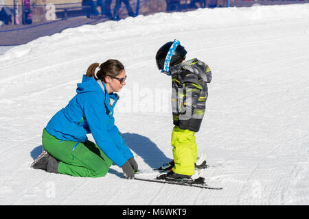 Ski Instructor with 3-Year Old Toddler Boy at a Mountain Resort Stock Photo