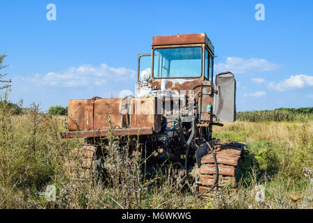 Old rusty disassembled combine harvester. Stock Photo